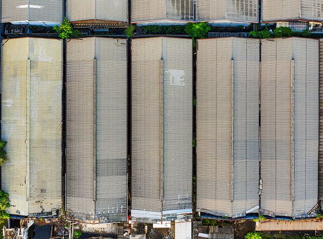 Aerial View Of A Large Warehouse Complex Featuring Multiple Rooftops And Surrounding Areas