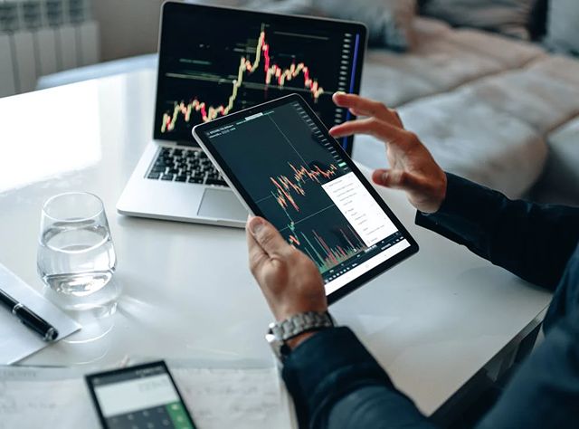 Man Analyzing Stock Market Graph On A Tablet