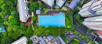 Aerial View Of A Swimming Pool Nestled Among Tall Buildings