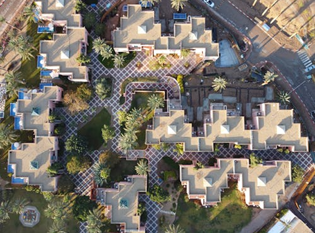 Overhead Perspective Of A Sprawling Apartment Complex With Several Structures And Landscaped Areas